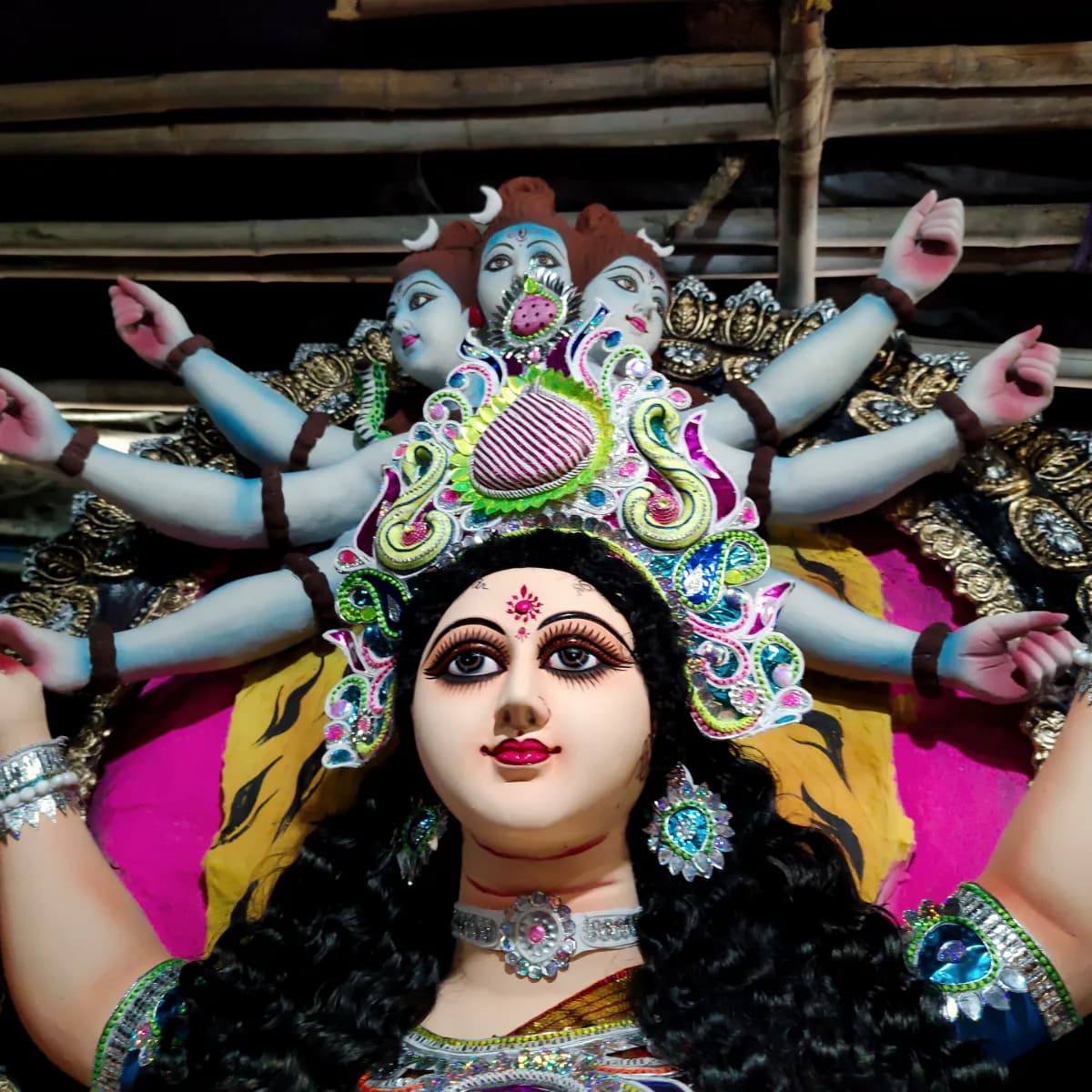A Durga murti prepared for Navratri, her many arms raised