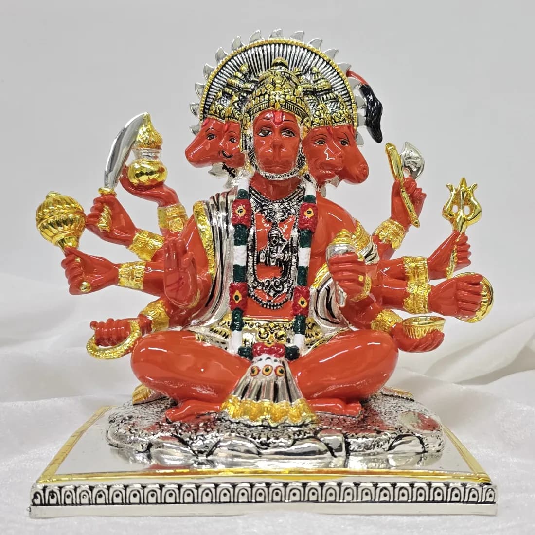 A Panchmukhi Hanuman figure in vermilion and gold